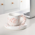 Ceramic coffee cup and saucer set featuring an orange splash ink design and a thick handle - Ink Splatter Red Fat Cup + Saucer