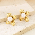 Close-up of golden petal stud earrings with white pearl center on a stone texture - Gold Flat Petal With Pearl (KE114180-KFC)