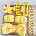 Detail view of 16-piece bright yellow hair accessory set with velvet tray and coral fleece bands - Yellow (16-Piece Set)