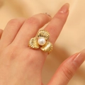 Golden leaf textured ring featuring a round white pearl on a fashion model's finger - Pearl Clover Style (11822)