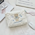 Detail of white quilted cosmetic bag featuring cute bear embroidery and woven handle - Cloud Animal