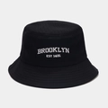 Close-up of Brooklyn EST 1631 white embroidery on premium black cotton bucket hat - M (56-58cm) / Black