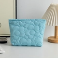 Detail of light blue quilted makeup bag with floral stitching and silver zipper closure - Sky Blue