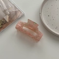Detail of a large rectangular hollow hair claw clip with pink marble acetate texture - Large Square Claw / Pink and Green