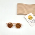 Detail view of round frame kids sunglasses with matte pink frames and amber lenses - Pink