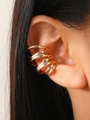 Detailed close-up of a gold multi-layer spiral ear cuff shown on the ear cartilage - Gold (X161) Clip-on