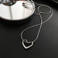 Elegant hollow heart pendant necklace in silver stainless steel on a sleek black background - 04-I14 Titanium Steel Heart Necklace Silver