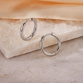 Elegant polished silver circular hoop earrings displayed on marble with silk fabric - Inner Diameter 14mm / Steel