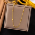 Elegant gold snake chain necklace with spherical beads displayed on a jewelry box - Round Snake Bead Chain (AH6011) / Gold