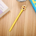 Cute yellow gel pen with creative 3D gingerbread house topper on a wooden desk - House Yellow