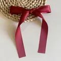 Close-up of wine red satin ribbon bow hair clip with elegant silk texture and long tails - Duckbill Hair Clips / Short/PC / Burgundy