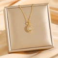 Elegante gouden titaniumstalen ketting met ovale hanger en zirkoon op zijdezachte achtergrond - Goud Ovalen Zirconia