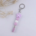 Close-up of purple silicone beads and leather tassel keychain with a flower bead detail - Light Purple