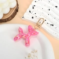 Pink holographic balloon dog keychain with golden metal clasp on elegant background - Iridescent Deep Pink