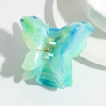 Detailed view of the gradient turquoise butterfly hair claw clip with golden metal spring - Blue-Green Gradient