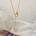 Minimalist gold geometric interlocking square pendant necklace on white silk background - Gold Square Style