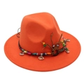 Close-up of bright orange fedora hat with ethnic beads and seashell decorative band - Orange