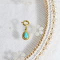 Gold bezel teardrop turquoise stone pendant on white lace and pearl background - Turquoise Teardrop
