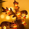 Close-up of reindeer LED string lights with warm yellow glow and wooden festive decor - 1m 10-LED (2AA Battery Model) / Clear Waving Reindeer