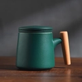 Dark green matte ceramic tea mug with a wooden handle and matching lid on a wooden table - Dark Green