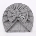 Close-up of baby turban hat in gray knit fabric featuring a large decorative bow - One Size / Gray