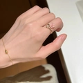 Close-up of pink enamel rose open ring and minimalist gold bead chain bracelet on hand - Rose