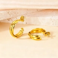 Detailed view of 18K gold C-shaped geometric earrings on marble and silk - 20mm (PJER440) / Gold