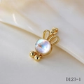 Macro view of a gold-plated rabbit pendant with iridescent moonstone and ear details - D123-1 Golden Rabbit Bell