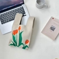 Beige knitted wrist bag with orange tulip embroidery pattern on a minimalist desk - Beige Tulip