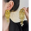 Detail of golden evil eye tassel earrings with white pearls worn by a model - Gold Pearl Evil Eye Earrings