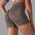 Seamless brown acid wash high waisted scrunch butt yoga shorts for women in a side view - Dark Brown