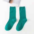Emerald green cotton crew socks with vertical rib texture in a flat lay display - Forest Green