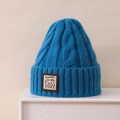 Detailed close-up of navy blue cable knit beanie with Lucky bear patch and ribbed cuff - 3-8 Years / Blue