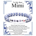 Dettaglio del bracciale in ceramica a fiori blu con perline MIMI su biglietto regalo - Mimi