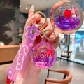 Cute purple rose oil-filled liquid keychain with pink silicone Sakura strap and gold ring - Lanyard Style / Purple