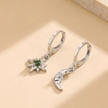 Silver asymmetrical star and moon hoop earrings with a green center gemstone - Silver with Green Zircon