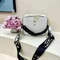 Close-up of white lychee leather square box bag with dual zippers and wide woven strap - White