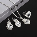 Silver alloy heart jewelry set with necklace earrings and ring on a grey book - Necklace Earrings Ring Set / White