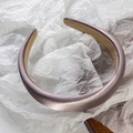 Detailed macro view of the lavender satin headband with a metallic sheen and soft nonslip lining - Purple