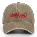Detailed macro shot of vintage red 3D embroidery text on washed cotton baseball cap - Khaki