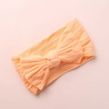 Detail view of baby jacquard headband showing soft ribbed texture and bow design - Peach Yellow