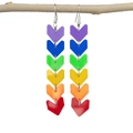 Rainbow acrylic chevron fringe earrings hanging on a branch over a white background - Rainbow Arrow Hooks