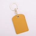 Close-up of yellow PU leather key fob holder with detailed stitching and metal buckle - Square / Beige