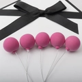 Pink balloon cake toppers made of clay with metal wires on a white background - Single Piece / Rose Red Single Ball