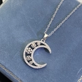 Macro view of silver crescent moon necklace with snowflake inlay on blue jewelry box - Silver (8299)