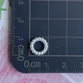 Macro shot of white ABS pearl bead on grid mat showing 1.5 cm diameter size detail - Round