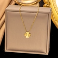 Detail of a gold clover necklace with radial texture on a brown leather display case - [XLH359] Heart Clover Necklace Gold