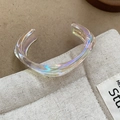 Macro shot of iridescent wavy acrylic bangle showing colorful aurora light effects on fabric - Iridescent - Triangle Shape