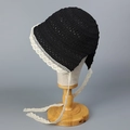 Close-up of a black hollow crochet sun hat featuring delicate white lace trim and ribbons - M (56-58cm) / Black