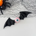 Halloween bat wing hair clip with a spooky eyeball detail in black and red finish - Black Eyeball